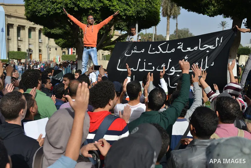 Egyptian students, who are members of Students Against the Coup group (SAC), take part in a demonstration against the military rule, at Cairo University on December 9, 2014. Photo by Amr Sayed
