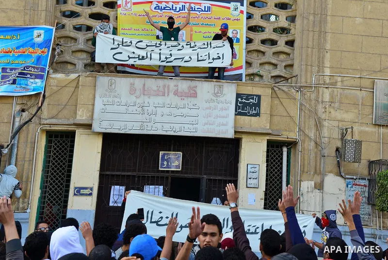 Egyptian students, who are members of Students Against the Coup group (SAC), take part in a demonstration against the military rule, at Cairo University on December 9, 2014. Photo by Amr Sayed