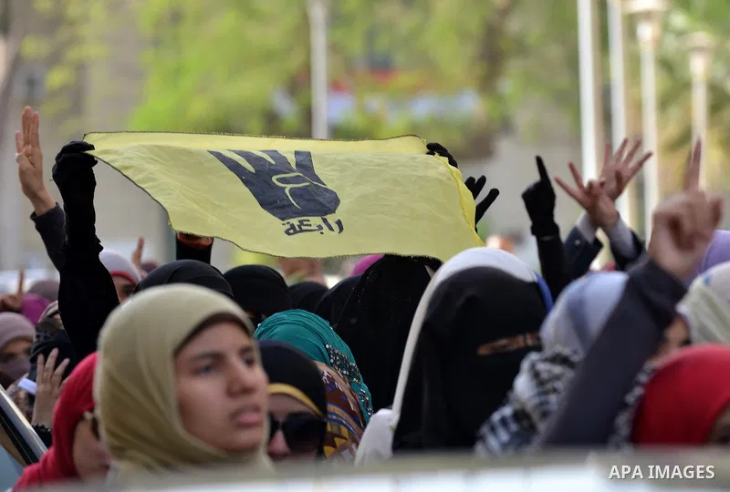 Egyptian students, who are members of Students Against the Coup group (SAC), take part in a demonstration against the military rule, at Cairo University on December 9, 2014. Photo by Amr Sayed