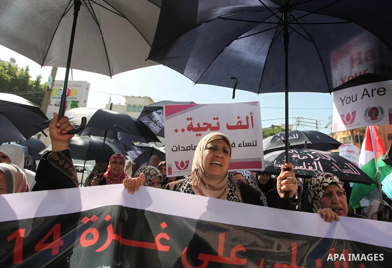 Palestinian women take part in a demonstration to mark the International Day of Human Rights, in Gaza City on December 10, 2014. The Palestinians are seeking a UN resolution by year-end that would set a timetable for Isr...