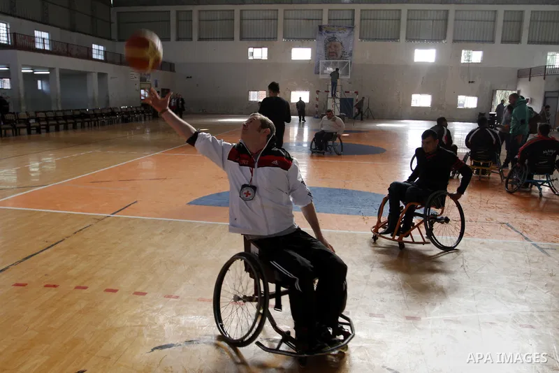 Disabled Palestinians play a basketball match during a championship organised by the Palestinian Red Cross to mark the International Day of Human Rights, in Khan Younis in the southern Gaza Strip, on December 10, 2014. T...