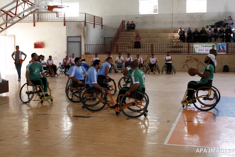 Disabled Palestinians play a basketball match during a championship organised by the Palestinian Red Cross to mark the International Day of Human Rights, in Khan Younis in the southern Gaza Strip, on December 10, 2014. T...