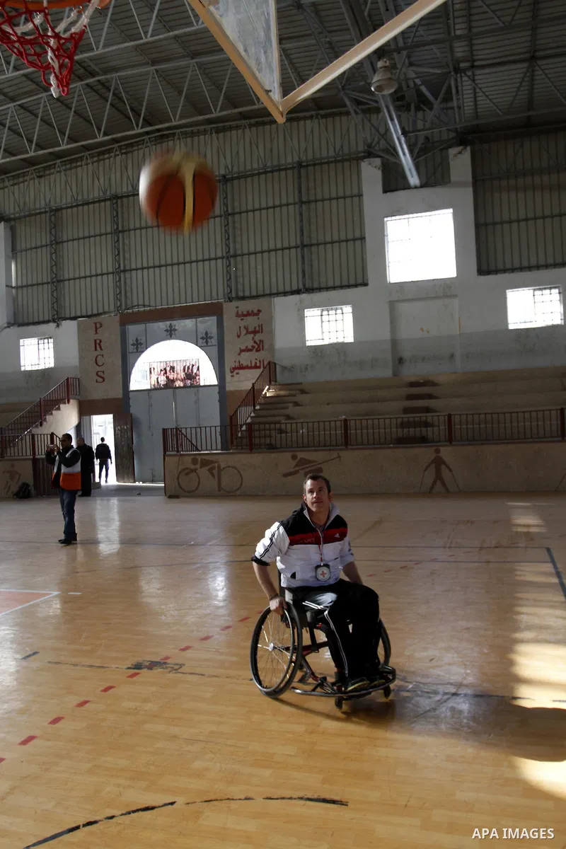 Disabled Palestinians play a basketball match during a championship organised by the Palestinian Red Cross to mark the International Day of Human Rights, in Khan Younis in the southern Gaza Strip, on December 10, 2014. T...