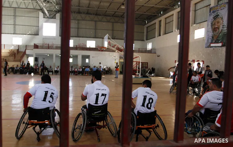 Disabled Palestinians play a basketball match during a championship organised by the Palestinian Red Cross to mark the International Day of Human Rights, in Khan Younis in the southern Gaza Strip, on December 10, 2014. T...