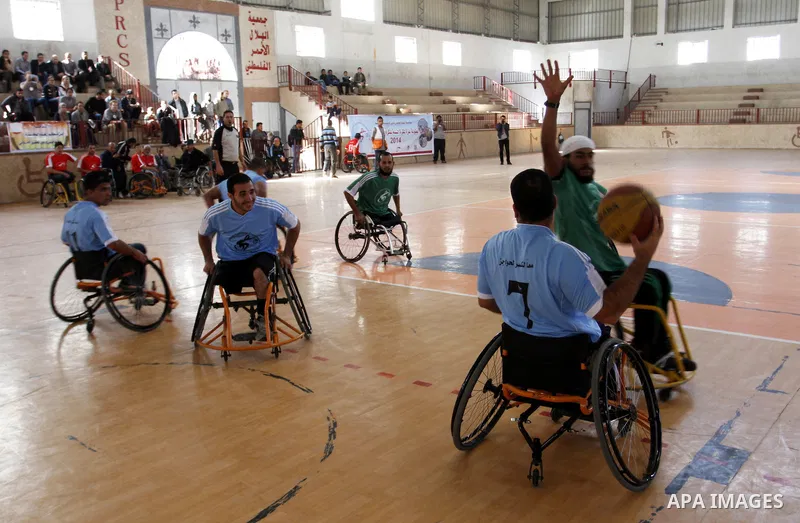 Disabled Palestinians play a basketball match during a championship organised by the Palestinian Red Cross to mark the International Day of Human Rights, in Khan Younis in the southern Gaza Strip, on December 10, 2014. T...