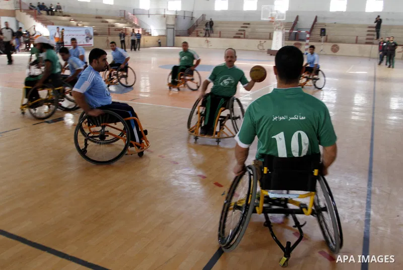Disabled Palestinians play a basketball match during a championship organised by the Palestinian Red Cross to mark the International Day of Human Rights, in Khan Younis in the southern Gaza Strip, on December 10, 2014. T...