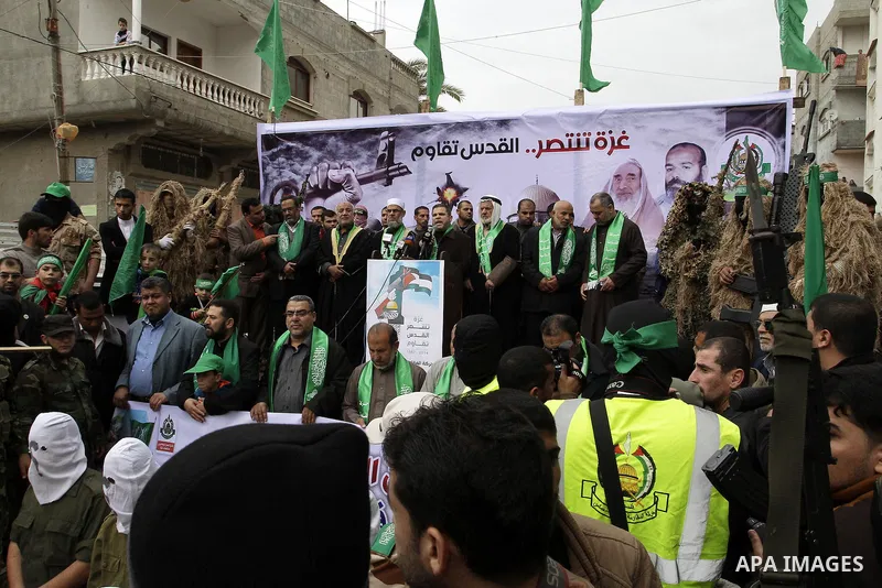 Supporters of Hamas take part during a rally to commemorate the 27th anniversary of the Islamist movement s creation, at the Nuseirat refugee camp in the Central Gaza Strip on December 12, 2014. Photo by Abed Rahim Khati...