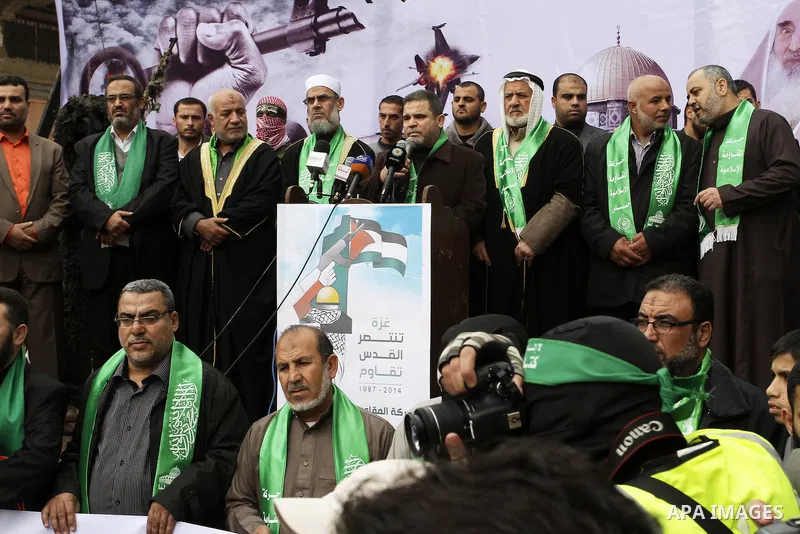 Supporters of Hamas take part during a rally to commemorate the 27th anniversary of the Islamist movement s creation, at the Nuseirat refugee camp in the Central Gaza Strip on December 12, 2014. Photo by Abed Rahim Khati...
