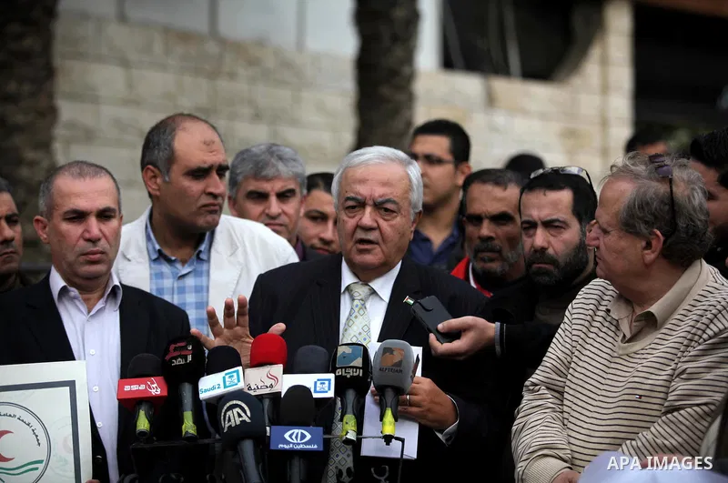 Palestinian Labor Minister Mamoun Abu Shahla, speaks during a protest organised by the Union of Health Work Committees, outside the Palestinian cabinet, in Gaza city on December 17, 2014. Photo by Ashraf Amra