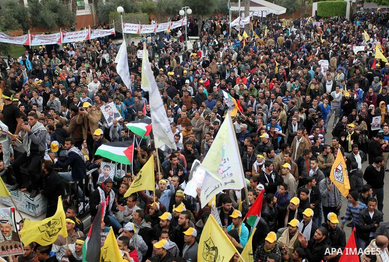 Palestinian supporters of former leader of Fatah in Gaza, Mohammed Dahlan, hold posters depicting Dahlan during a protest against Palestinian President Mahmoud Abbas in Gaza City December 18, 2014. Dahlan, who lives in e...