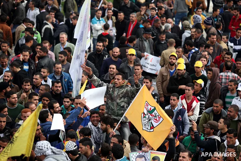 Palestinian supporters of former leader of Fatah in Gaza, Mohammed Dahlan, hold posters depicting Dahlan during a protest against Palestinian President Mahmoud Abbas in Gaza City December 18, 2014. Dahlan, who lives in e...