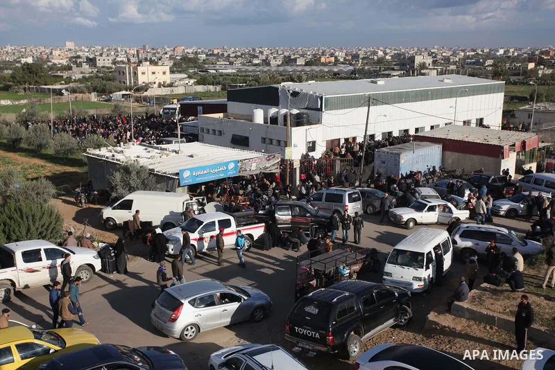 Palestinians hoping to cross into Egypt, wait with their relatives at the Rafah crossing between Egypt and the southern Gaza Strip December 21, 2014. Egypt opened the Rafah border crossing on Sunday allowing Palestinians...