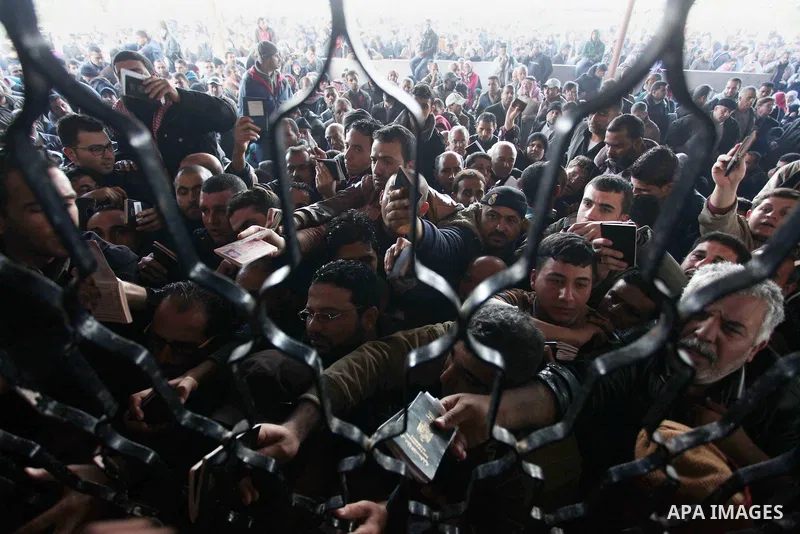 Palestinians hoping to cross into Egypt, wait with their relatives at the Rafah crossing between Egypt and the southern Gaza Strip December 21, 2014. Egypt opened the Rafah border crossing on Sunday allowing Palestinians...