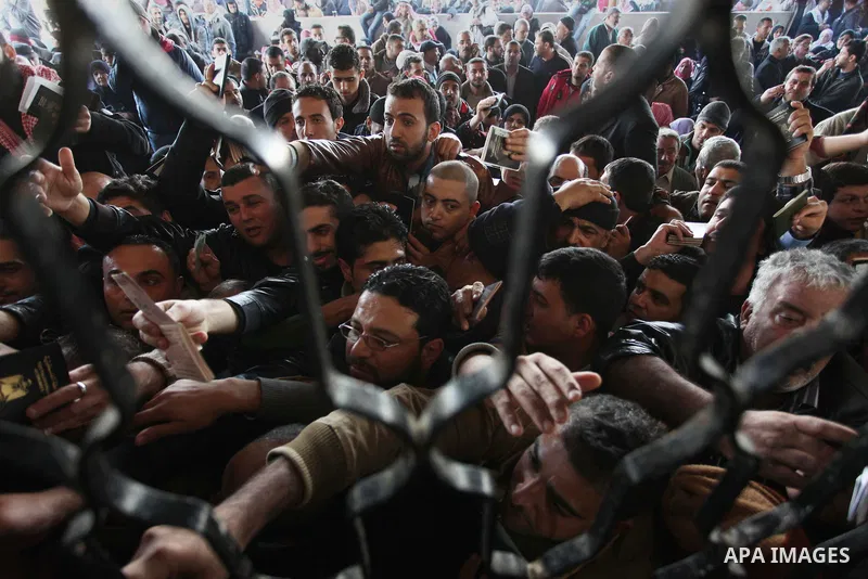 Palestinians hoping to cross into Egypt, wait with their relatives at the Rafah crossing between Egypt and the southern Gaza Strip December 21, 2014. Egypt opened the Rafah border crossing on Sunday allowing Palestinians...