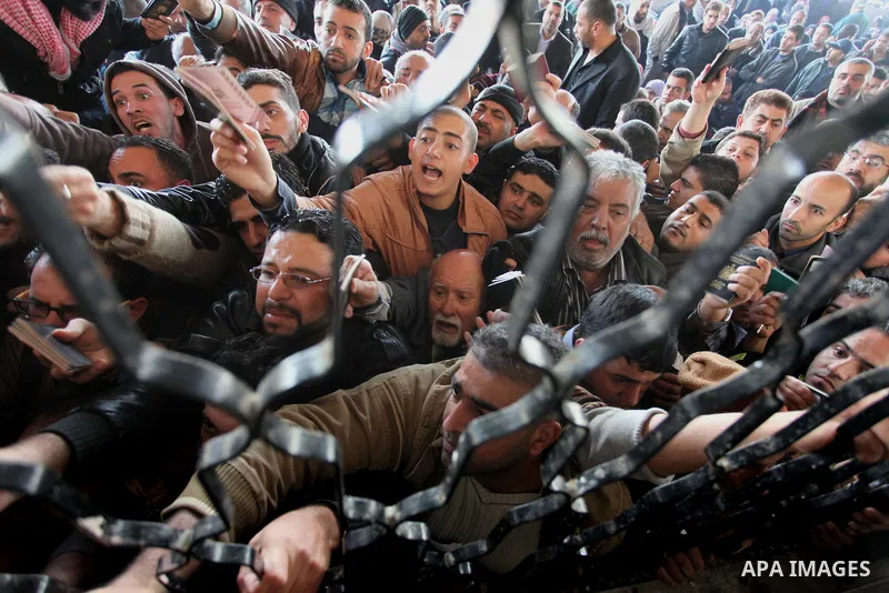 Palestinians hoping to cross into Egypt, wait with their relatives at the Rafah crossing between Egypt and the southern Gaza Strip December 21, 2014. Egypt opened the Rafah border crossing on Sunday allowing Palestinians...
