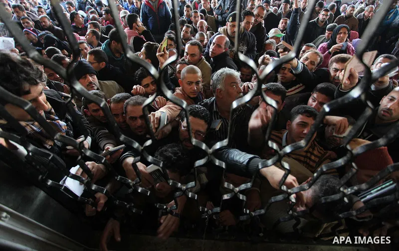 Palestinians hoping to cross into Egypt, wait with their relatives at the Rafah crossing between Egypt and the southern Gaza Strip December 21, 2014. Egypt opened the Rafah border crossing on Sunday allowing Palestinians...