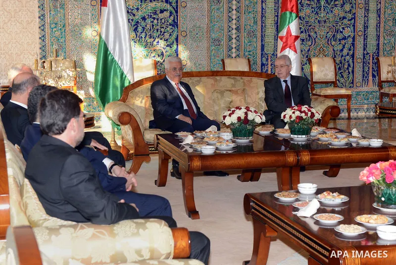 Palestinian president Mahmoud Abbas meets with Algerian Prime Minister Abdelmalek Sellal and President of the Council of the Nation Abdelkader Bensalah upon his arrival at Houari Boumediene Airport outside the capital Al...