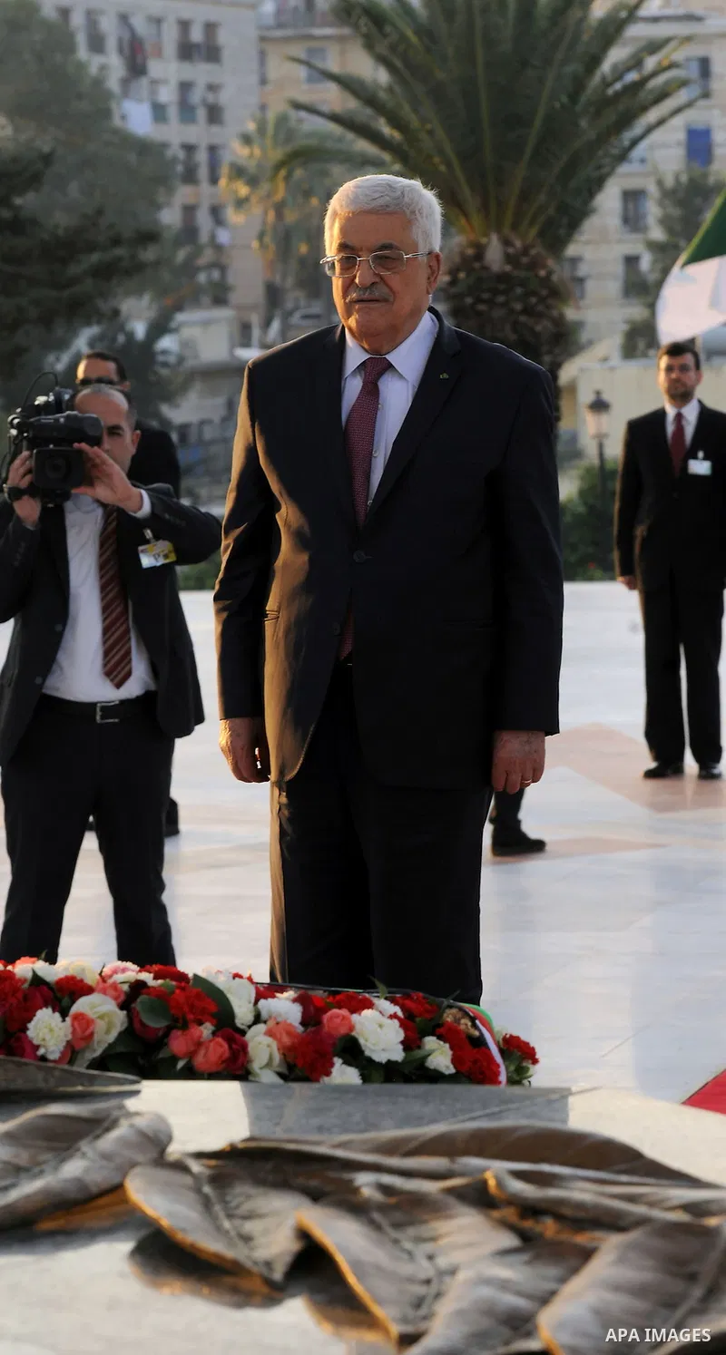 Palestinian President Mahmoud Abbas lays a wreath at the tomb of the Unknown Soldier, in Algeria on December 21, 2014. Abbas is on a three-day official visit and he is expected to meet several officials. Photo by Thaer G...