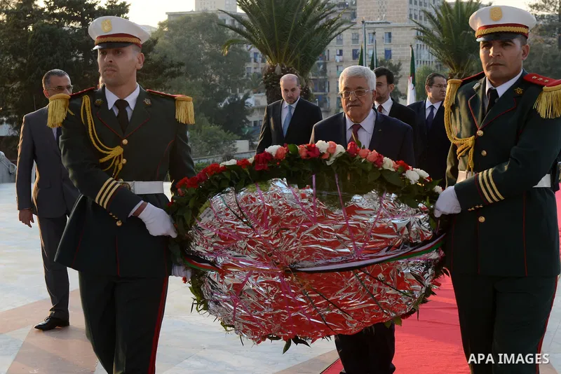 Palestinian President Mahmoud Abbas lays a wreath at the tomb of the Unknown Soldier, in Algeria on December 21, 2014. Abbas is on a three-day official visit and he is expected to meet several officials. Photo by Thaer G...