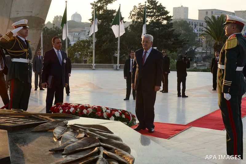 Palestinian President Mahmoud Abbas lays a wreath at the tomb of the Unknown Soldier, in Algeria on December 21, 2014. Abbas is on a three-day official visit and he is expected to meet several officials. Photo by Thaer G...