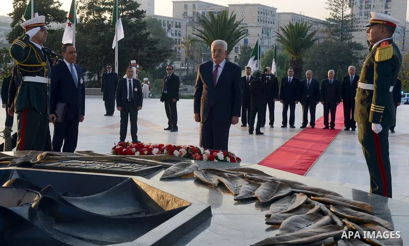 Palestinian President Mahmoud Abbas lays a wreath at the tomb of the Unknown Soldier, in Algeria on December 21, 2014. Abbas is on a three-day official visit and he is expected to meet several officials. Photo by Thaer G...