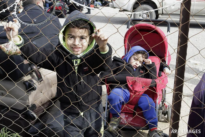 Palestinians await permission to enter Egypt as they gather at the Rafah border crossing between Egypt and southern Gaza Strip on December 22, 2014. Around 630 Palestinians left Gaza and entered the Egyptian Sinai throug...