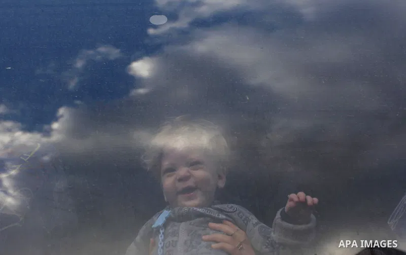 A Palestinian boy, hoping to cross into Egypt with her family, looks out a bus window at the Rafah crossing between Egypt and the southern Gaza Strip December 23, 2014. Egypt opened the Rafah border crossing on Sunday fo...