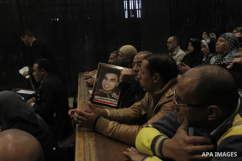 A relative of a killed man in the 'Port Said Massacre' holds his picture during the trial of suspects in Cairo on December 23, 2014. The defendants were originally given sentences ranging from 15 years to life in prison....