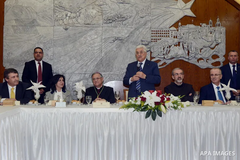 Palestinian President Mahmoud Abba visits a dinner at Franciscan monastery in the West Bank city of Bethlehem December 24, 2014. Photo by Thaer Ganaim