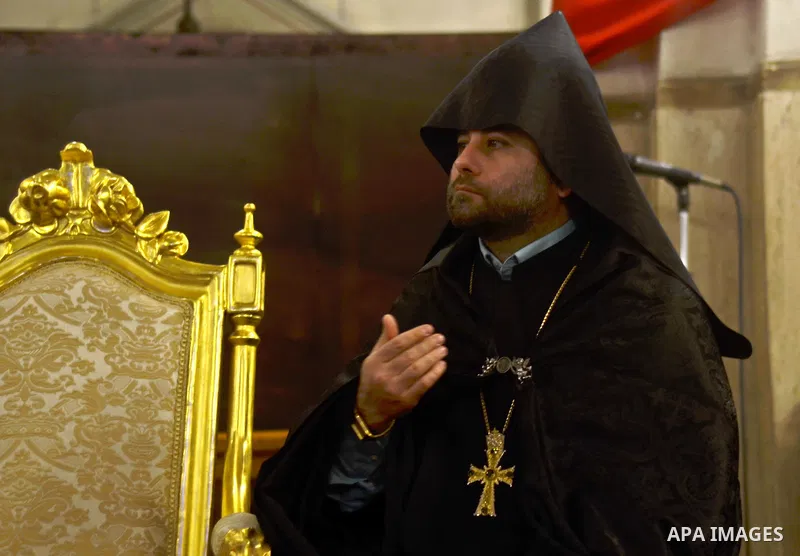 Armenian Catholic Bishop of Alexandria, Krikor Augustine Kusa, (not seen) attends an annual Christmas celebration, at Boutrerreqih Abdeen, in cairo, Egypt, on December 25, 2014. Photo by Amr Sayed