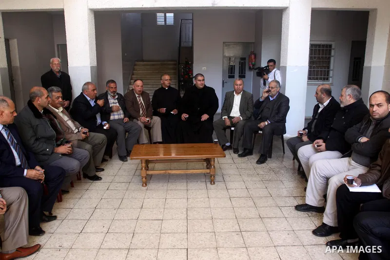Leaders of the Palestinian parties and factions visit the Gaza Latin Church to deliver congratulations in the Christmas holiday, in Gaza city on December 25, 2014. Photo by Mohammed Asad