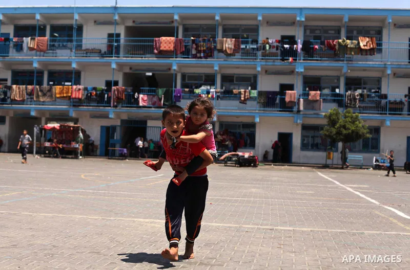 Displaced Palestinian children play at an United Nations (UN) school in Jabalia in the northern Gaza Strip, where they found refugee with their family after fleeing their home in an area under heavy Israeli bombardment i...