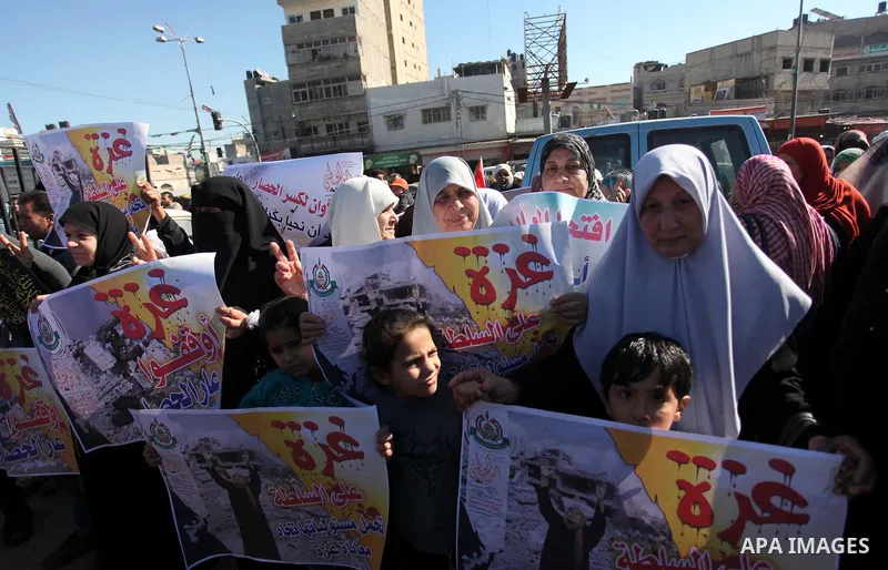 Palestinians take part in a protest calling for end the Israeli illegal blockade on Gaza Strip and against the slow rehabilitation of the strip after damage incurred during the recent Israeli offensive on Gaza Strip, in...