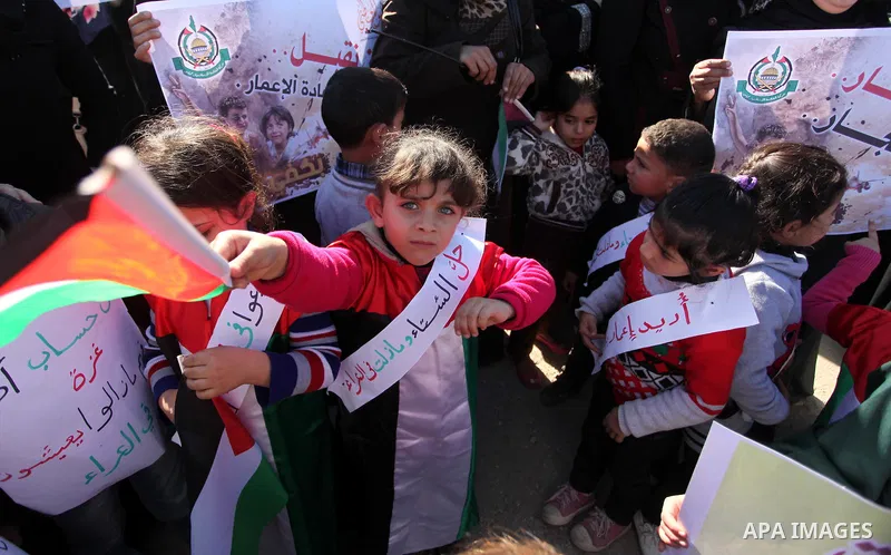 Palestinians take part in a protest calling for end the Israeli illegal blockade on Gaza Strip and against the slow rehabilitation of the strip after damage incurred during the recent Israeli offensive on Gaza Strip, in...