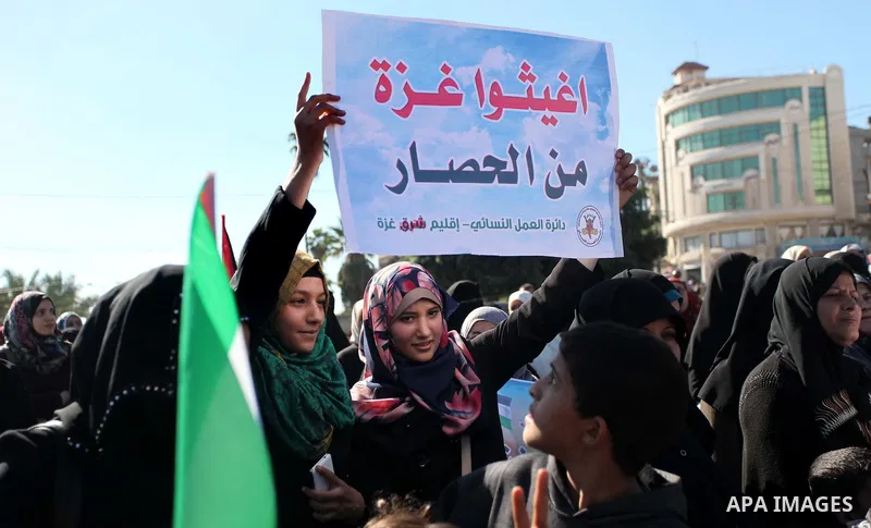 Palestinians take part in a protest calling for end the Israeli illegal blockade on Gaza Strip and against the slow rehabilitation of the strip after damage incurred during the recent Israeli offensive on Gaza Strip, in...