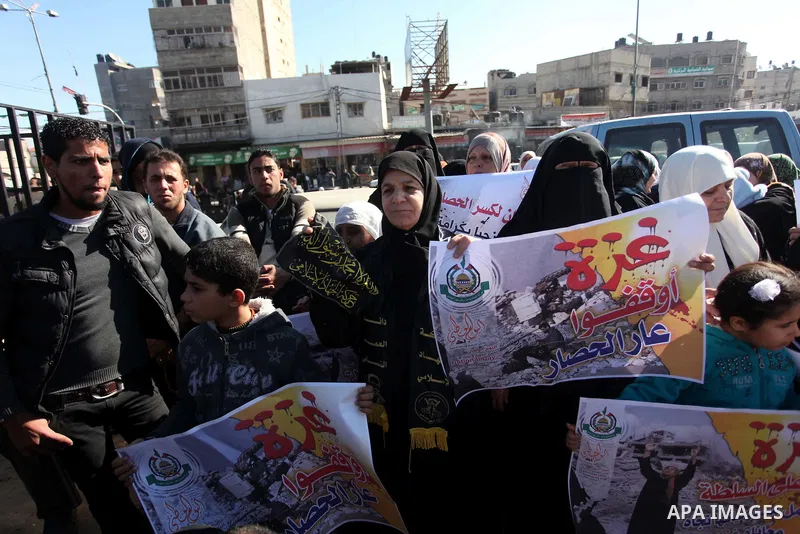 Palestinians take part in a protest calling for end the Israeli illegal blockade on Gaza Strip and against the slow rehabilitation of the strip after damage incurred during the recent Israeli offensive on Gaza Strip, in...