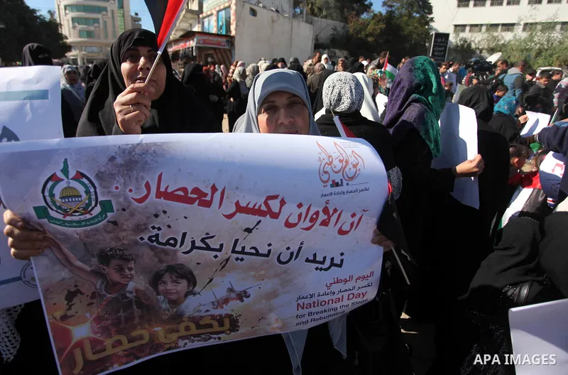 Palestinians take part in a protest calling for end the Israeli illegal blockade on Gaza Strip and against the slow rehabilitation of the strip after damage incurred during the recent Israeli offensive on Gaza Strip, in...