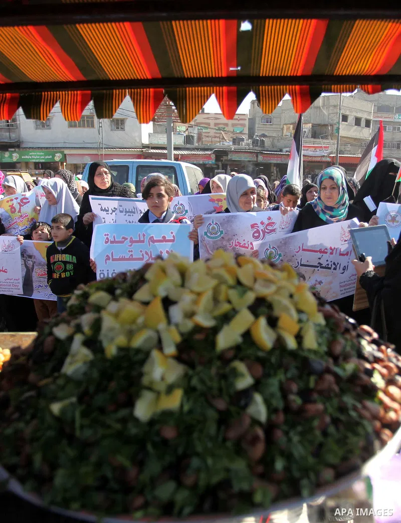 Palestinians take part in a protest calling for end the Israeli illegal blockade on Gaza Strip and against the slow rehabilitation of the strip after damage incurred during the recent Israeli offensive on Gaza Strip, in...
