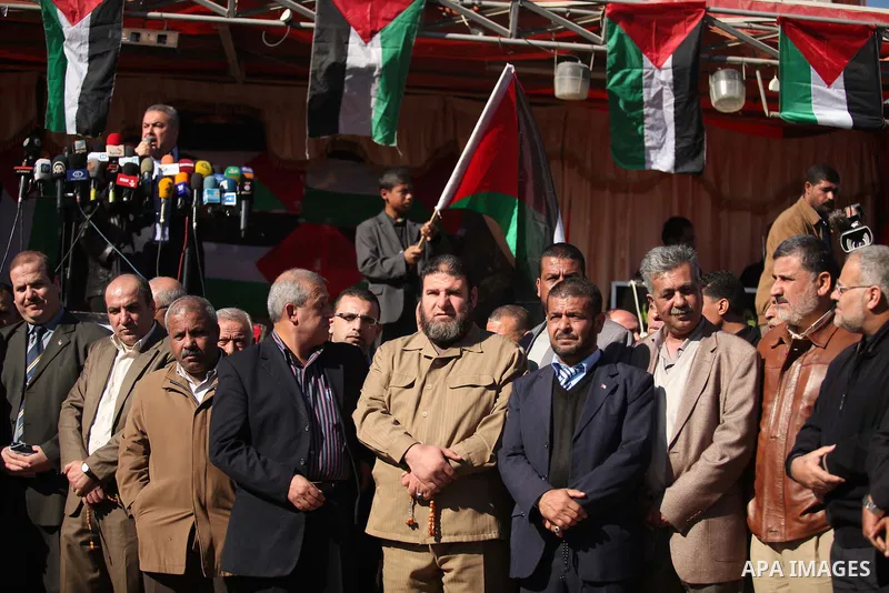 Palestinians take part in a protest calling for end the Israeli illegal blockade on Gaza Strip and against the slow rehabilitation of the strip after damage incurred during the recent Israeli offensive on Gaza Strip, in...