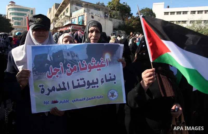 Palestinians take part in a protest calling for end the Israeli illegal blockade on Gaza Strip and against the slow rehabilitation of the strip after damage incurred during the recent Israeli offensive on Gaza Strip, in...