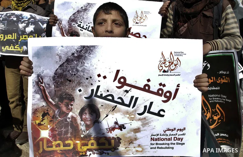 Palestinians take part in a protest calling for end the Israeli illegal blockade on Gaza Strip and against the slow rehabilitation of the strip after damage incurred during the recent Israeli offensive on Gaza Strip, in...