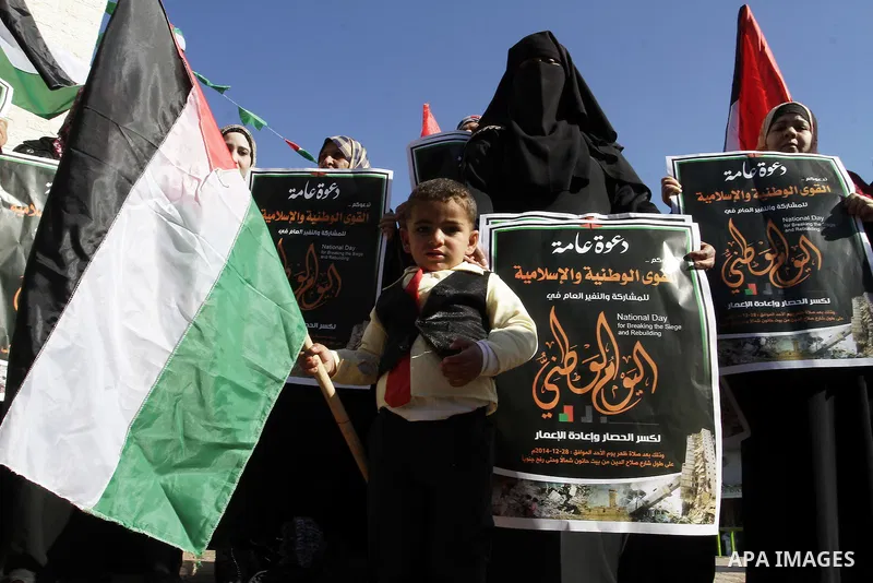 Palestinians take part in a protest calling for end the Israeli illegal blockade on Gaza Strip and against the slow rehabilitation of the strip after damage incurred during the recent Israeli offensive on Gaza Strip, in...