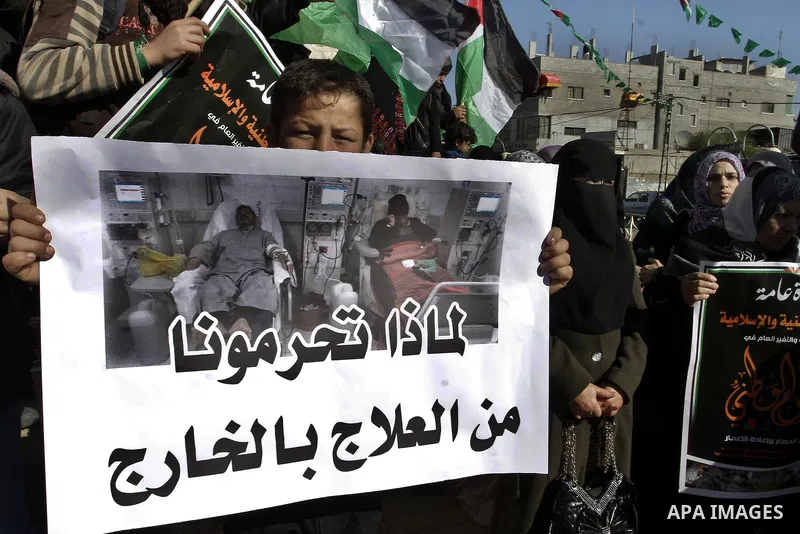 Palestinians take part in a protest calling for end the Israeli illegal blockade on Gaza Strip and against the slow rehabilitation of the strip after damage incurred during the recent Israeli offensive on Gaza Strip, in...