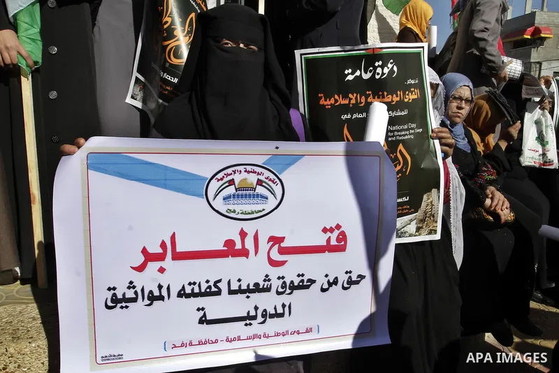 Palestinians take part in a protest calling for end the Israeli illegal blockade on Gaza Strip and against the slow rehabilitation of the strip after damage incurred during the recent Israeli offensive on Gaza Strip, in...