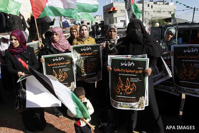 Palestinians take part in a protest calling for end the Israeli illegal blockade on Gaza Strip and against the slow rehabilitation of the strip after damage incurred during the recent Israeli offensive on Gaza Strip, in...
