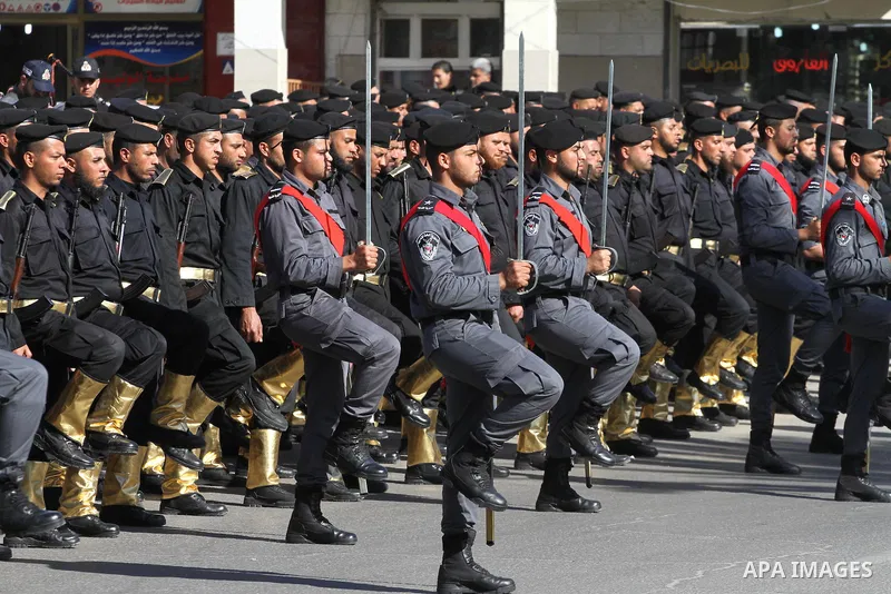 Palestinian members of national security forces march during a military rally to commemorated the sixth anniversary of the beginning of Israel's 22-day offensive on the Gaza Strip in 2008-9 that left more than 1,400 dead...