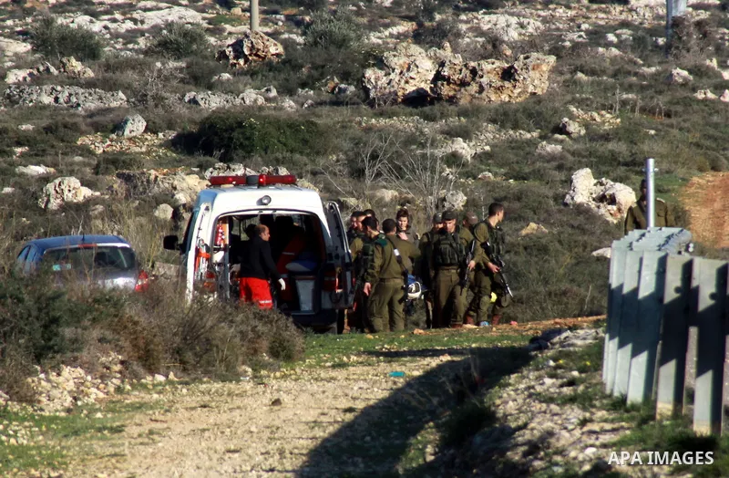Israeli soldiers carry the body of Palestinian Imam Dwikat after he was shot dead by Israeli troops near the West Bank village of Beita near Nablus December 29, 2014. Israeli soldiers shot and killed Dwikat who had been...