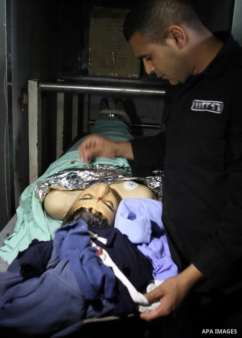A relative mourns over the body of Palestinian Imam Dwikat after he was shot dead by Israeli troops near the West Bank village of Beita, at a hospital morgue in Nablus December 29, 2014. Israeli soldiers shot and killed...