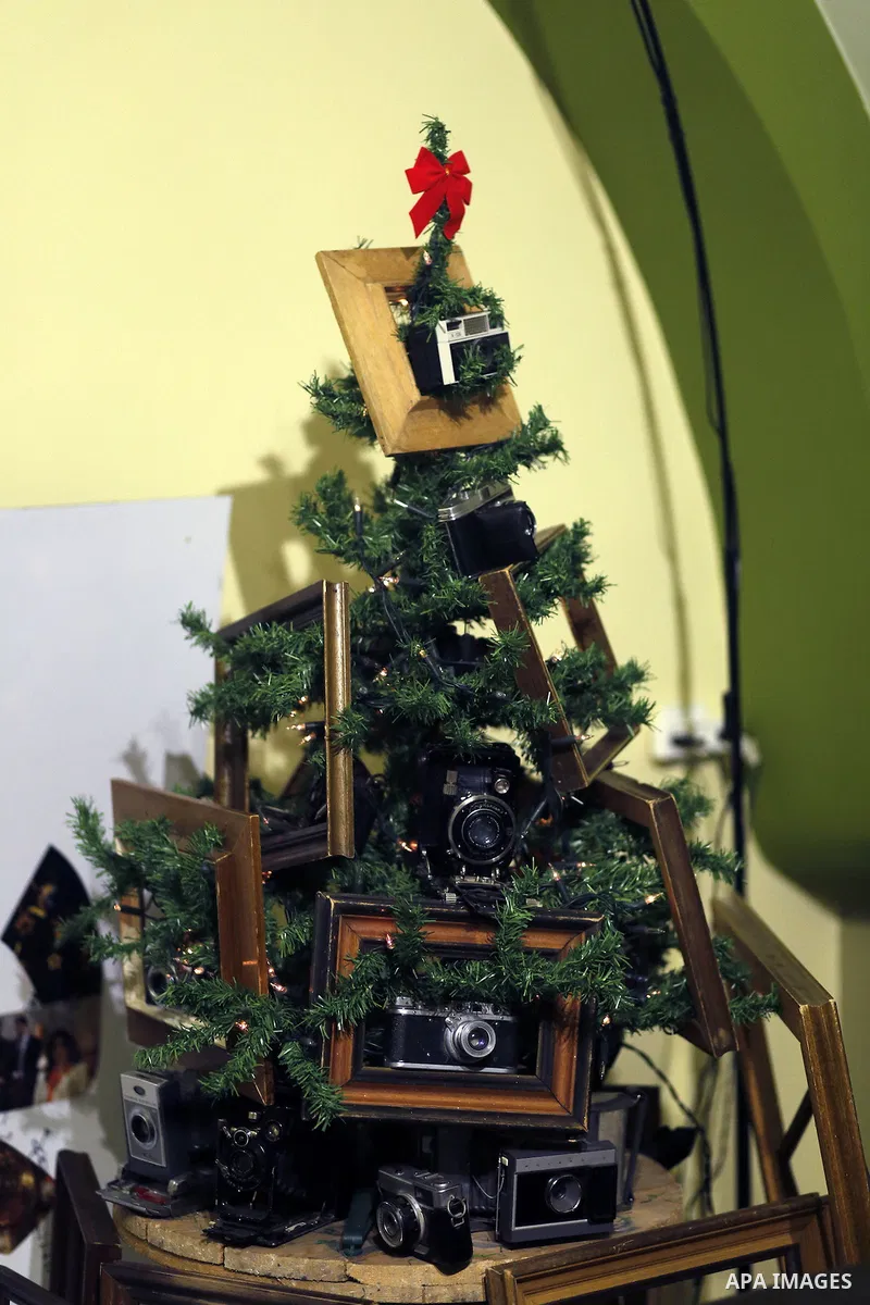 Palestinian Photographer, Elias Halabi, decorates a Christmas tree with cameras old at his house in the West Bank city of Bethlehem December 29, 2014. Photo by Muhesen Amren