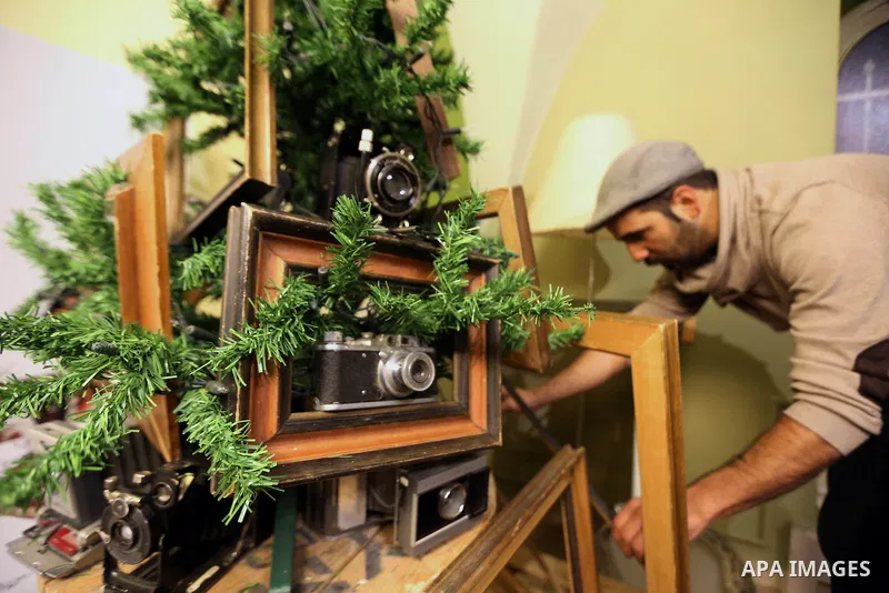 Palestinian Photographer, Elias Halabi, decorates a Christmas tree with cameras old at his house in the West Bank city of Bethlehem December 29, 2014. Photo by Muhesen Amren